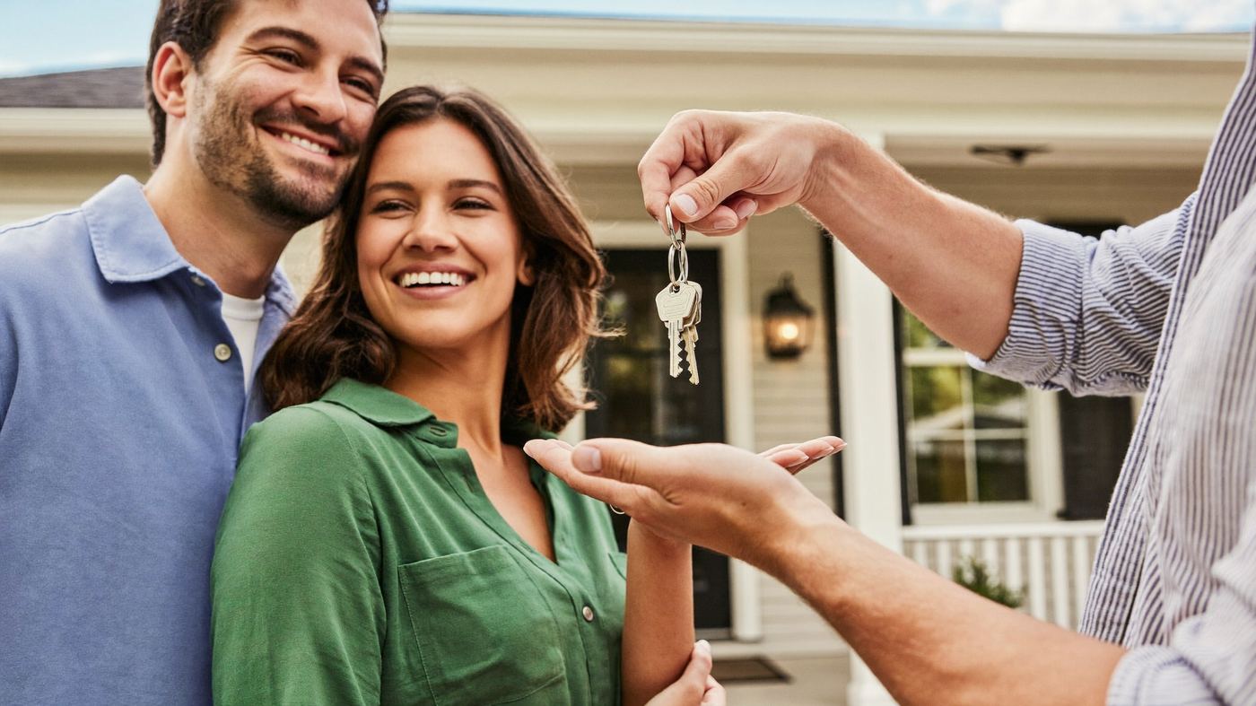 Family receiving the keys to their new home at the front porch